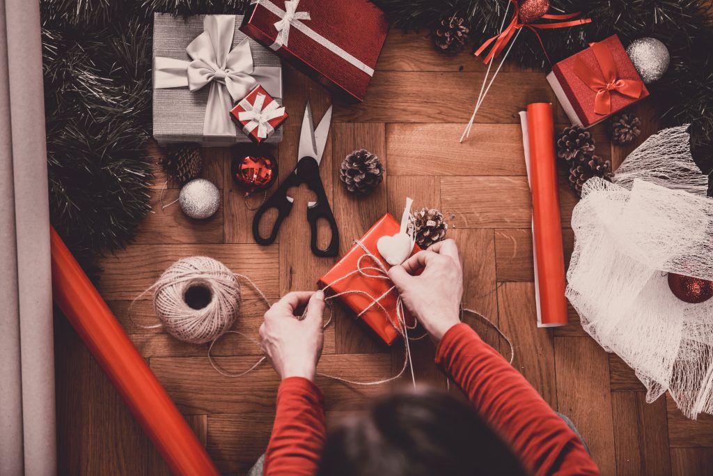 Woman wrapping a present to illustrate gadgets and gifts for Christmas Incentives | Element